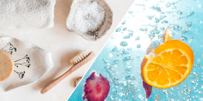 Toothbrush, salts, towel, pebbles and water with fruits